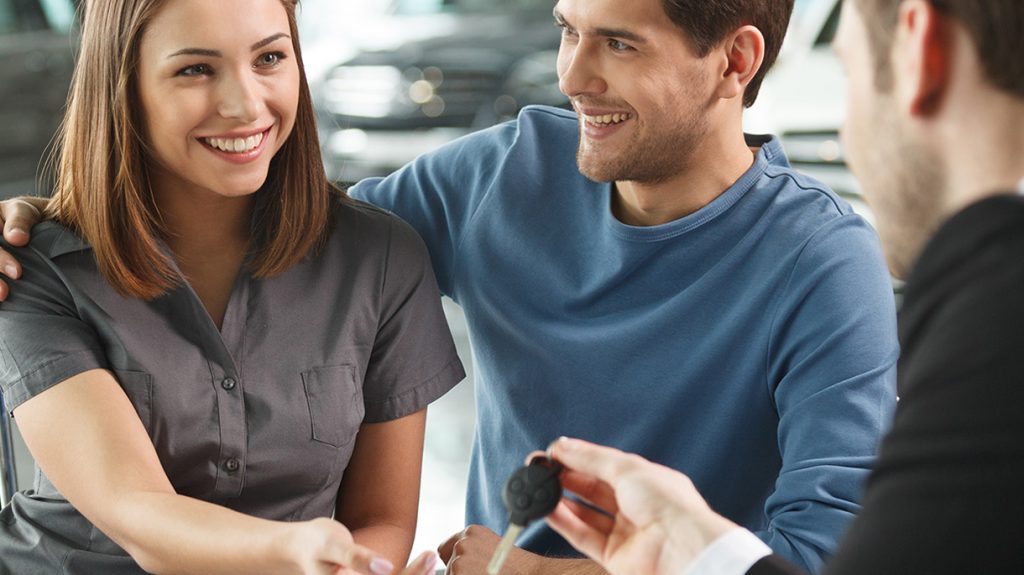 Couple having financing a GMC vehicle explained to them